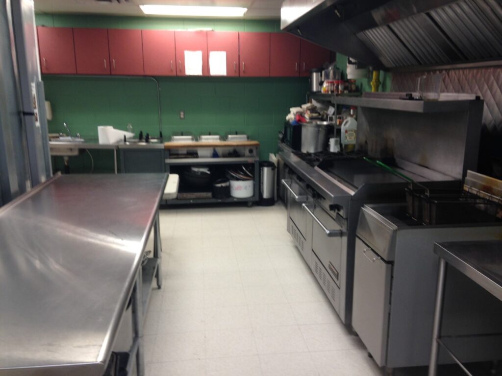 The kitchen, which is off to the right side of the gym/hall has a variety of stove ranges, refrigerators and cookware to use.