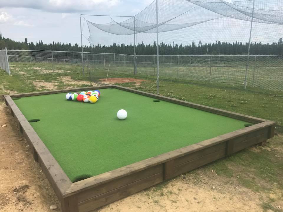 Snookball combines soccer and billiards outside on a giant looking pool table.
